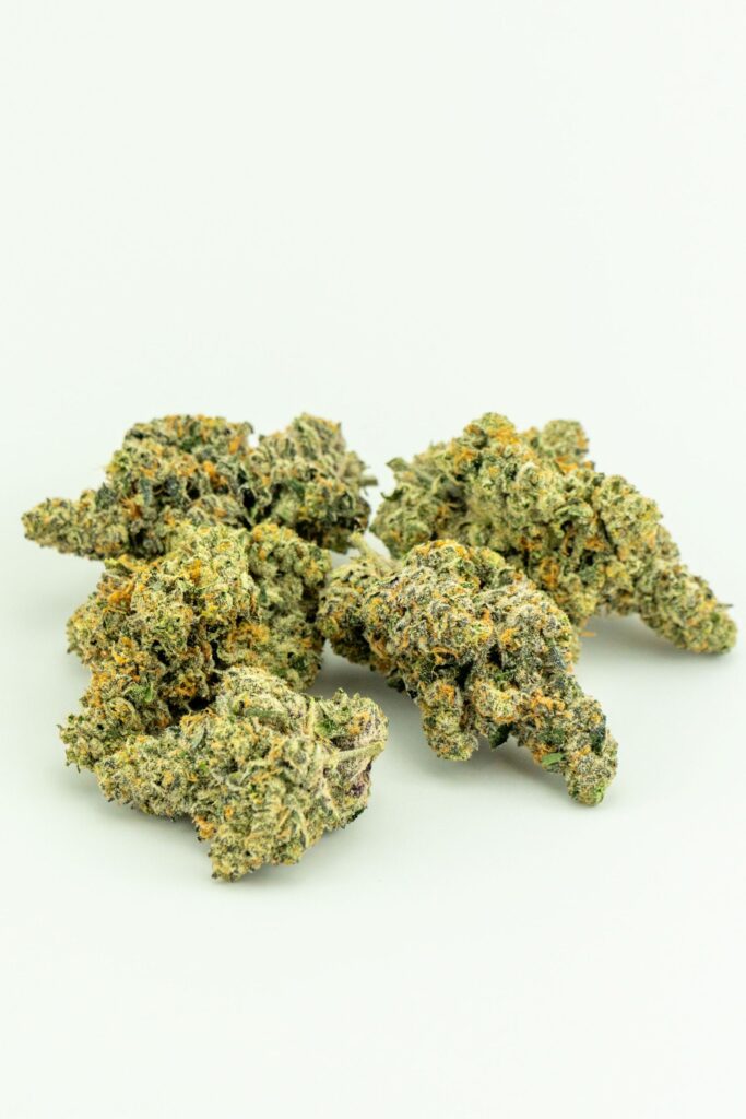 Beauty shot of a grouping of juicy Dark Sunset buds that are as strikingly green as they are purple, offering a sunset swirl.